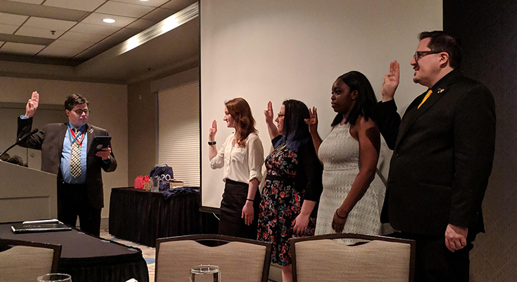Region Chair Justin Martin inducts the four Section Chairs into their newly-elected positions at APO's F1/F2/F3 Conference in Normal, IL, April 2019